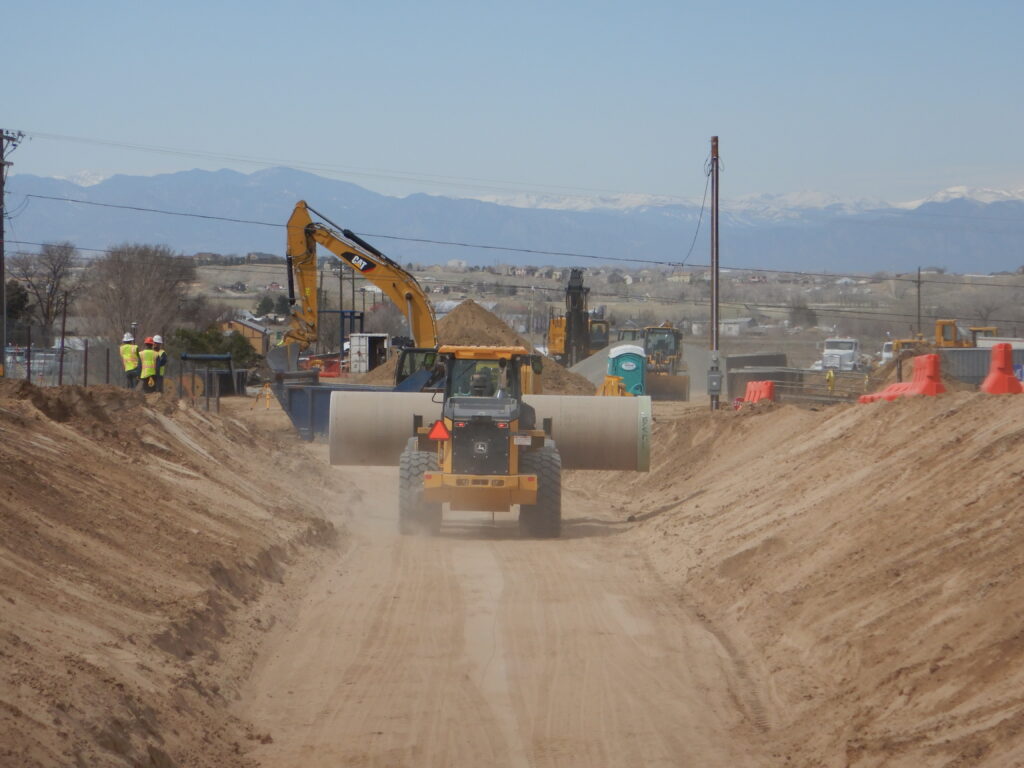 a photo of construction vehicles constructing a pipeline.