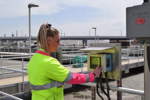 Cassandra Caley, In-Line Instrument Specialist II, working from an instrument panel near the aeration basins in the South Secondary complex at the Robert W. Hite Treatment Facility (RWHTF). 