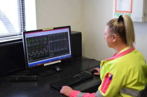 Cassandra Caley, In-Line Instrument Specialist II, reviews real-time data from the satellite lab in the South Secondary complex at RWHTF.