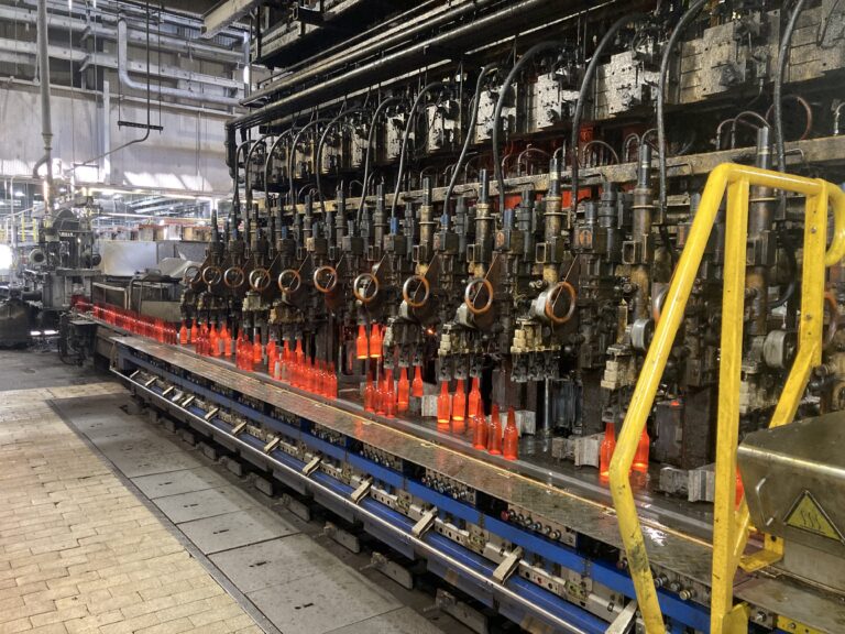 bottling machines in a row in an industrial setting