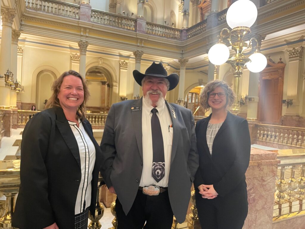 A photo of Metro's Dawn Ambrosio, Senator Will, and Kim after the bill passed