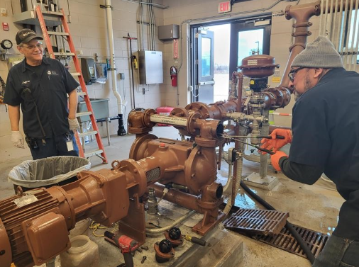 Operators fixing a pump
