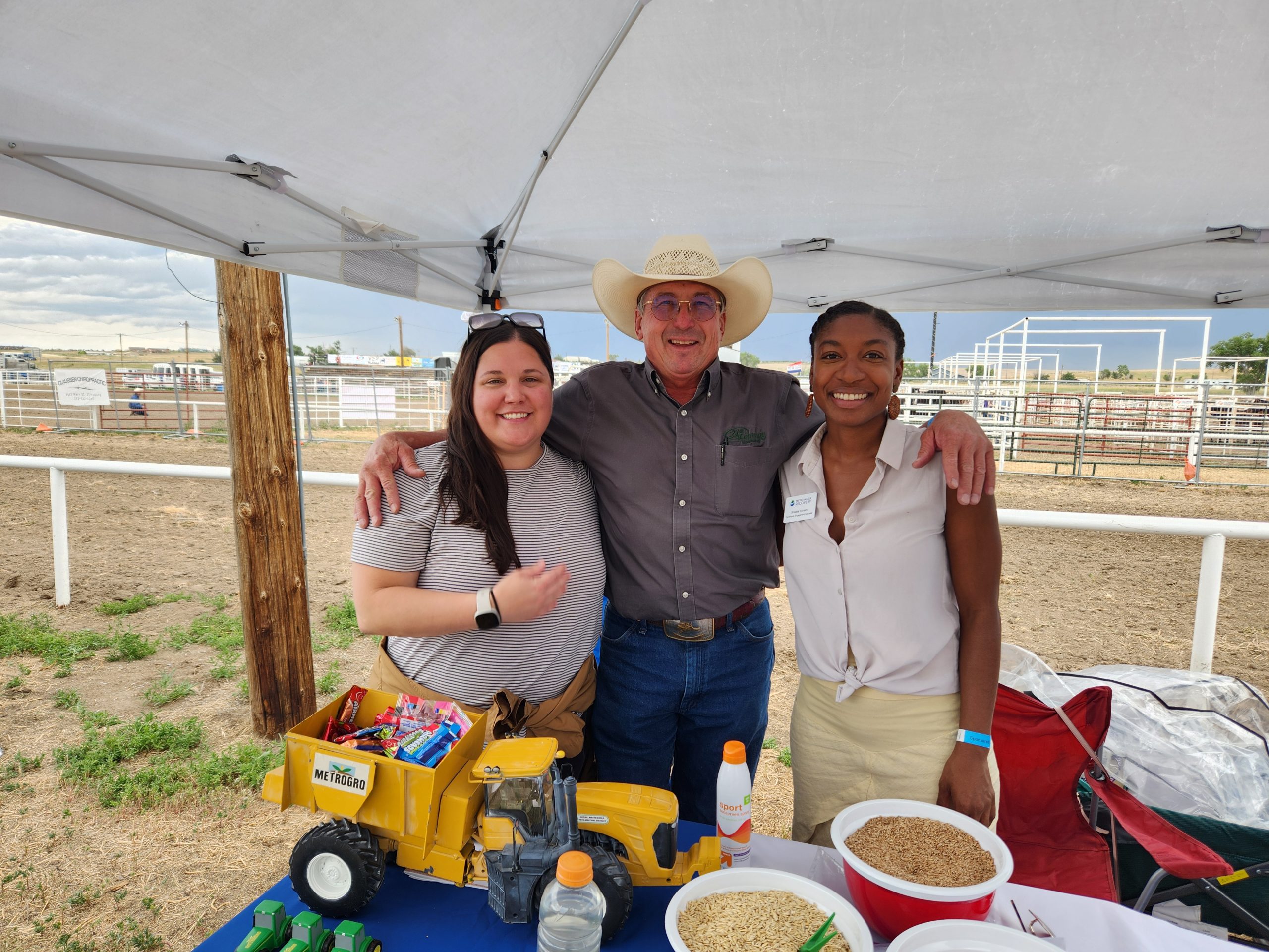 Members of Metro's Community Outreach meeting a patron at a rodeo.