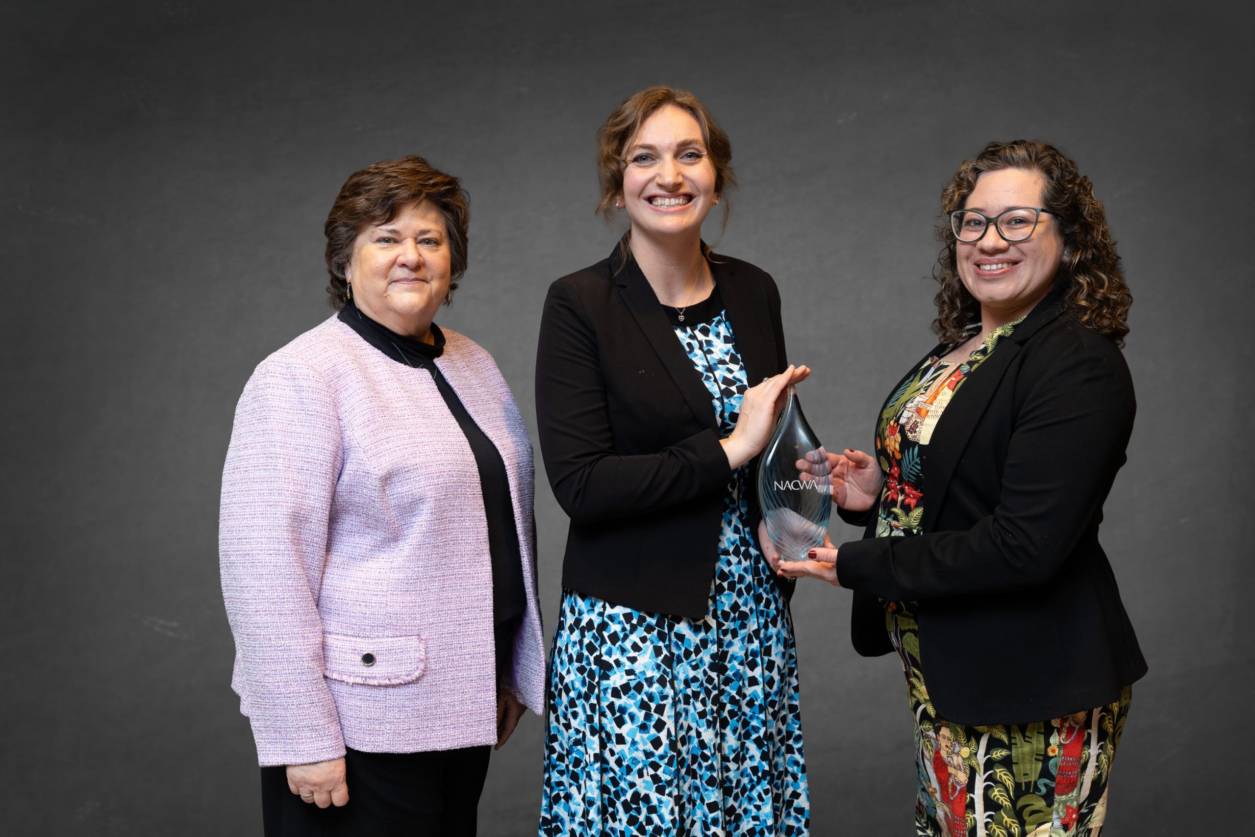 Public information officers Amy Lovatt and Maritza Franco posing with a trophy