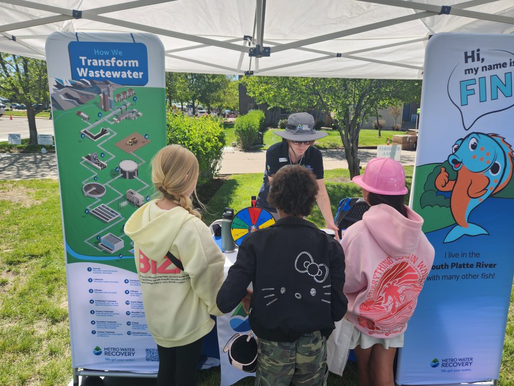 Public Information Officer Amy Lovatt speaking to kids at an event Metro Sponsors
